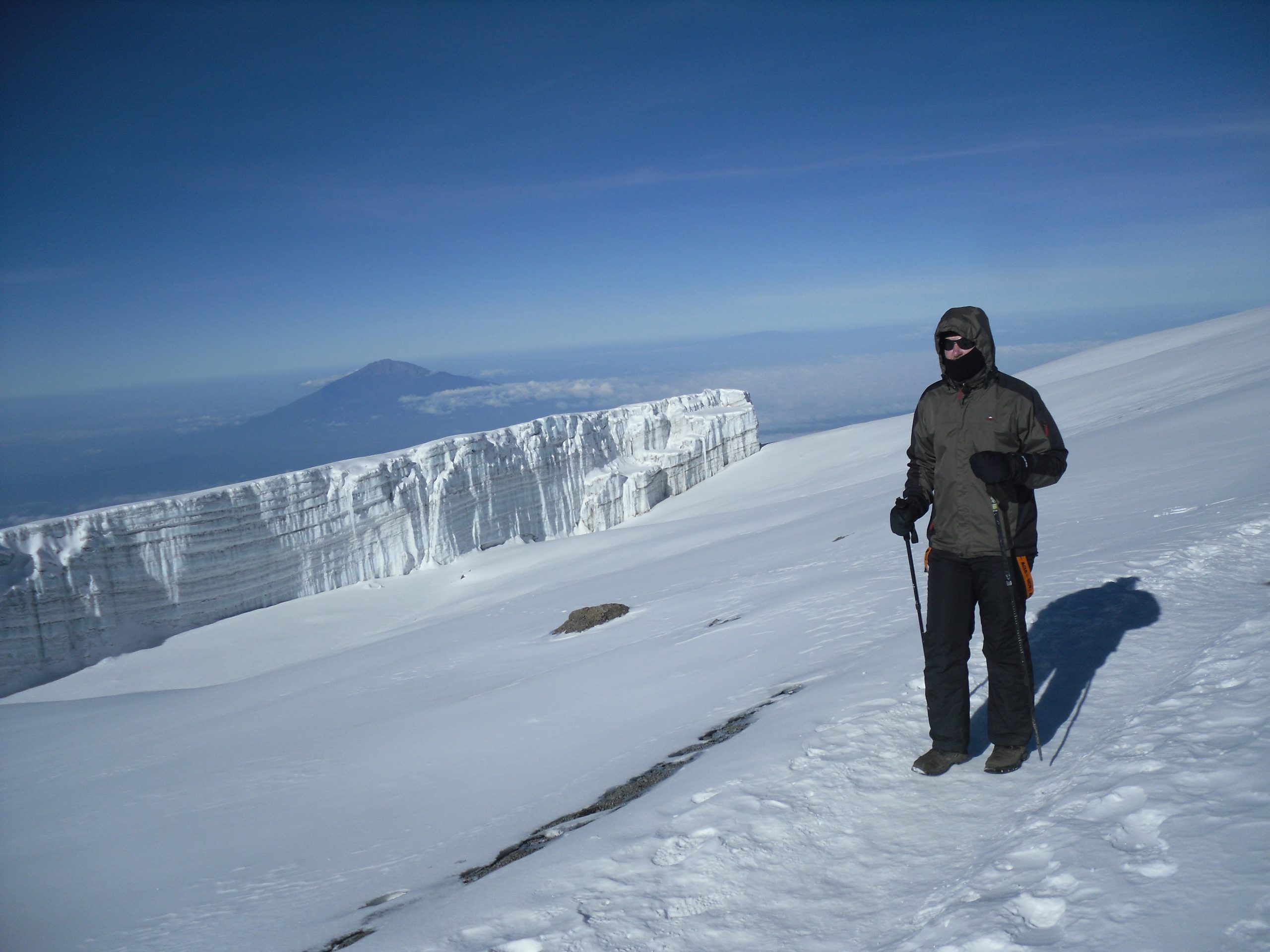 Pristine white snowfields and massive, towering glaciers gleaming in the sunlight during the descent from Kilimanjaro's summit.